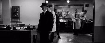 Movie still from “Pineapple Express” (2008), directed by David Gordon Green – A group of men standing in a room next to each other; Wide shot, Low angle