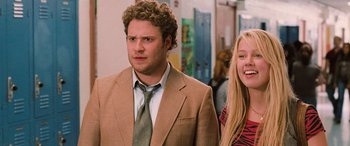 Movie still from “Pineapple Express” (2008), directed by David Gordon Green – A man and a woman standing next to each other in a hallway; Medium shot, Over the shoulder angle