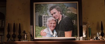 Movie still from “Pineapple Express” (2008), directed by David Gordon Green – An older woman and a younger man in a painting; Extreme Close Up shot, Low angle