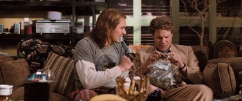 Movie still from “Pineapple Express” (2008), directed by David Gordon Green – Two men sitting on a couch looking at their cell phones; Medium shot, Overhead angle