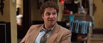 Movie still from “Pineapple Express” (2008), directed by David Gordon Green – A person wearing a suit and tie; Close Up shot, Over the shoulder angle