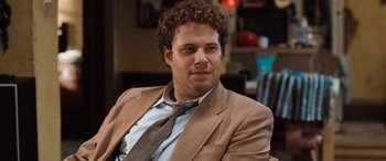 Movie still from “Pineapple Express” (2008), directed by David Gordon Green – A person wearing a suit and tie; Close Up shot, Over the shoulder angle