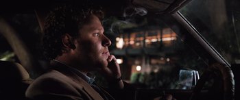 Movie still from “Pineapple Express” (2008), directed by David Gordon Green – A man sitting in the driver's seat of a car smoking; Close Up shot, Over the shoulder angle