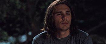 Movie still from “Pineapple Express” (2008), directed by David Gordon Green – A person with long brown hair; Close Up shot, Low angle