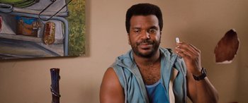 Movie still from “Pineapple Express” (2008), directed by David Gordon Green – A person wearing a vest; Close Up shot, Over the shoulder angle