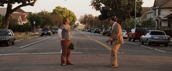 Movie still from “Pineapple Express” (2008), directed by David Gordon Green – Two people standing on the side of the road talking to each other; Wide shot, High angle