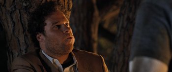 Movie still from “Pineapple Express” (2008), directed by David Gordon Green – A person wearing a suit and tie; Close Up shot, Over the shoulder angle