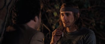 Movie still from “Pineapple Express” (2008), directed by David Gordon Green – A man with long brown hair is talking to another man; Close Up shot, Over the shoulder angle