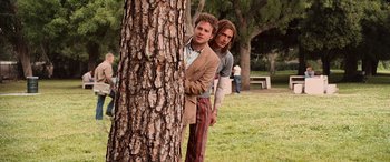 Movie still from “Pineapple Express” (2008), directed by David Gordon Green – A couple of men standing next to a tree; Medium shot, Low angle
