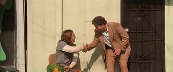 Movie still from “Pineapple Express” (2008), directed by David Gordon Green – Two men shaking hands in front of a wall; Medium shot, Over the shoulder angle
