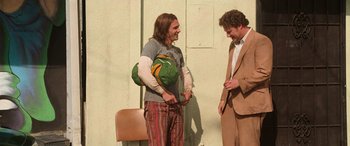 Movie still from “Pineapple Express” (2008), directed by David Gordon Green – Two men standing next to each other and laughing; Wide shot, Low angle