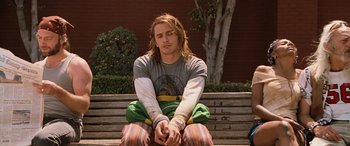 Movie still from “Pineapple Express” (2008), directed by David Gordon Green – A man sitting on top of a wooden bench; Medium shot, High angle