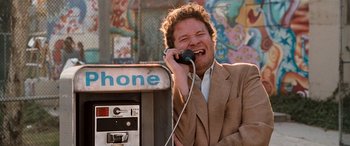 Movie still from “Pineapple Express” (2008), directed by David Gordon Green – A man in a brown suit is talking on a phone; Close Up shot, High angle