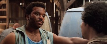 Movie still from “Pineapple Express” (2008), directed by David Gordon Green – A man in a blue tank top with a scar on his face; Close Up shot, Over the shoulder angle