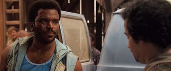 Movie still from “Pineapple Express” (2008), directed by David Gordon Green – A man standing in front of a truck; Close Up shot, Over the shoulder angle