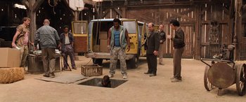 Movie still from “Pineapple Express” (2008), directed by David Gordon Green – A group of people standing around a hole in the ground; Wide shot, High angle
