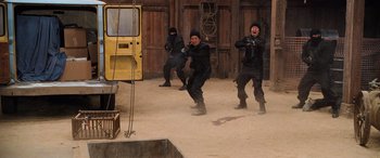 Movie still from “Pineapple Express” (2008), directed by David Gordon Green – A group of men in black suits and black hats; Wide shot, High angle