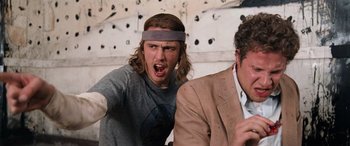 Movie still from “Pineapple Express” (2008), directed by David Gordon Green – A man with a headband is yelling at another man; Medium shot, Low angle