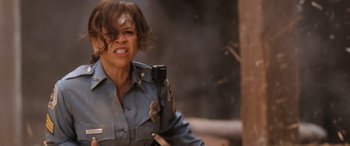 Movie still from “Pineapple Express” (2008), directed by David Gordon Green – A woman in a police officer's uniform; Close Up shot, Low angle