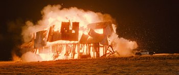 Movie still from “Pineapple Express” (2008), directed by David Gordon Green – A barn being destroyed by fire at night time; Extreme Wide shot, Low angle