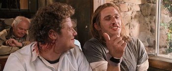 Movie still from “Pineapple Express” (2008), directed by David Gordon Green – Two men sitting next to each other on a couch; Close Up shot, Low angle