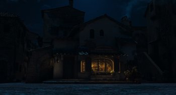 Movie still from “Pinocchio” (2022), directed by Robert Zemeckis – A building lit up at night in the dark; Extreme Wide shot, Low angle