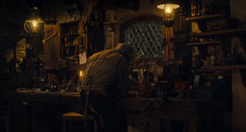 Movie still from “Pinocchio” (2022), directed by Robert Zemeckis – An old man working in a workshop with a lot of tools; Wide shot, High angle