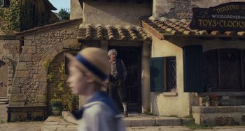 Movie still from “Pinocchio” (2022), directed by Robert Zemeckis – An old man standing in front of an old house; Wide shot, Over the shoulder angle