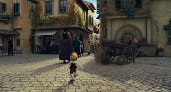 Movie still from “Pinocchio” (2022), directed by Robert Zemeckis – An image of an animated character in a village setting; Extreme Wide shot, High angle