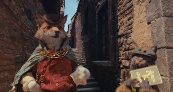 Movie still from “Pinocchio” (2022), directed by Robert Zemeckis – A fox dressed in a top hat and a red jacket; Medium shot, Over the shoulder angle