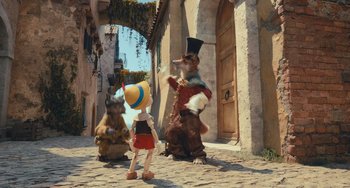Movie still from “Pinocchio” (2022), directed by Robert Zemeckis – A group of people standing next to each other on a street; Wide shot, High angle