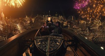 Movie still from “Pinocchio” (2022), directed by Robert Zemeckis – Two people are riding in a boat in a theme park; Extreme Wide shot, High angle