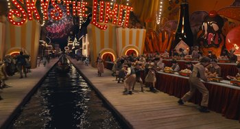 Movie still from “Pinocchio” (2022), directed by Robert Zemeckis – A group of people walking down a boardwalk next to water; Extreme Wide shot, High angle