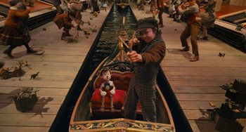 Movie still from “Pinocchio” (2022), directed by Robert Zemeckis – A child sitting in a boat on the water; Wide shot, High angle