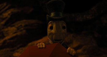 Movie still from “Pinocchio” (2022), directed by Robert Zemeckis – A toy character holding an umbrella; Extreme Close Up shot, High angle