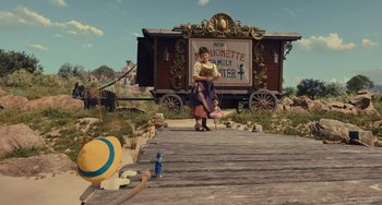 Movie still from “Pinocchio” (2022), directed by Robert Zemeckis – A woman sitting on the ground in front of a train; Wide shot, Low angle