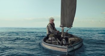 Movie still from “Pinocchio” (2022), directed by Robert Zemeckis – An old man sitting on a boat in the middle of the ocean; Wide shot, High angle