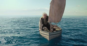 Movie still from “Pinocchio” (2022), directed by Robert Zemeckis – An old man sitting in a boat in the middle of the ocean; Wide shot, High angle