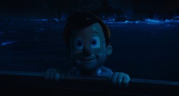Movie still from “Pinocchio” (2022), directed by Robert Zemeckis – A statue of pinocchio looking over a bridge; Close Up shot, High angle