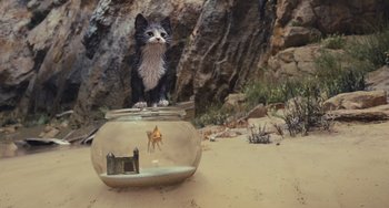 Movie still from “Pinocchio” (2022), directed by Robert Zemeckis – A cat sitting on top of a fish bowl on the beach; Wide shot, Low angle