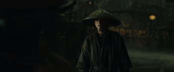 Movie still from “Pirates of the Caribbean: At World's End” (2007), directed by Gore Verbinski – A person wearing a hat standing in a dark room; Close Up shot, Over the shoulder angle