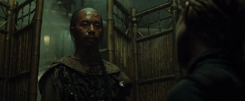Movie still from “Pirates of the Caribbean: At World's End” (2007), directed by Gore Verbinski – A man with a face paint and a necklace; Close Up shot, Over the shoulder angle