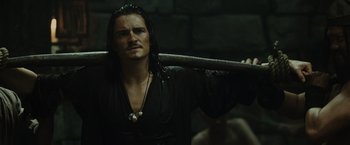 Movie still from “Pirates of the Caribbean: At World's End” (2007), directed by Gore Verbinski – A man with long hair holding onto a stick; Close Up shot, Over the shoulder angle
