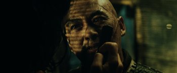 Movie still from “Pirates of the Caribbean: At World's End” (2007), directed by Gore Verbinski – A man with a bald head is looking at the camera; Close Up shot, Over the shoulder angle