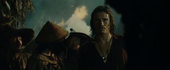 Movie still from “Pirates of the Caribbean: At World's End” (2007), directed by Gore Verbinski – A man with long dark hair wearing a black shirt; Close Up shot, Low angle