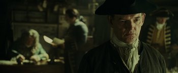 Movie still from “Pirates of the Caribbean: At World's End” (2007), directed by Gore Verbinski – A man wearing a black hat and a white shirt; Close Up shot, Over the shoulder angle