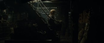 Movie still from “Pirates of the Caribbean: At World's End” (2007), directed by Gore Verbinski – A woman sitting on top of a set of stairs; Wide shot, High angle
