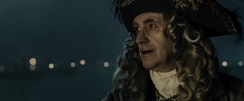 Movie still from “Pirates of the Caribbean: At World's End” (2007), directed by Gore Verbinski – An old man in a pirate costume with long blonde hair; Close Up shot, Over the shoulder angle
