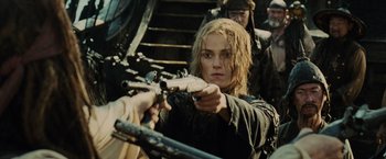 Movie still from “Pirates of the Caribbean: At World's End” (2007), directed by Gore Verbinski – A woman is holding a rifle and aiming at a camera; Close Up shot, Over the shoulder angle