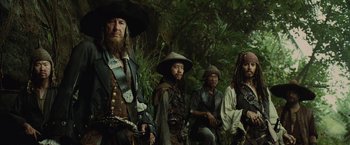 Movie still from “Pirates of the Caribbean: At World's End” (2007), directed by Gore Verbinski – A group of people dressed as pirates in a forest; Medium shot, Low angle